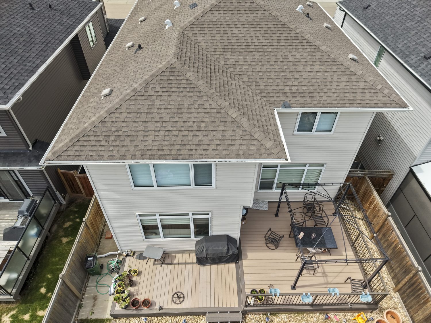Aerial view of a client's home, roof and backyard